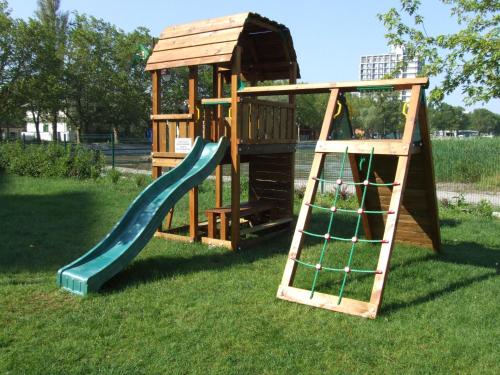 a wooden playground with a slide and a ladder at Club218 Wellness Apartments in Siófok