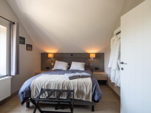 a bedroom with a large bed and a window at Vakantiewoning Mierzicht met privé wellness in Gingelom