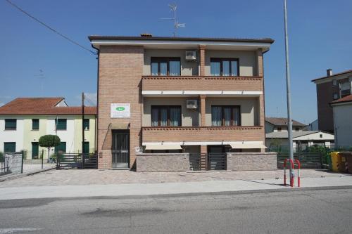 a tall brick building on the corner of a street at Le Terrazze Rooms & Studios in Ferrara