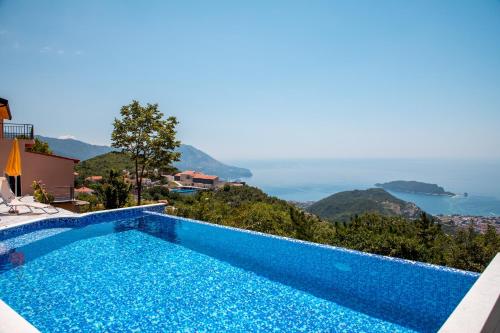 a villa with a swimming pool and a view at Villas Adriatic Horizonte in Budva