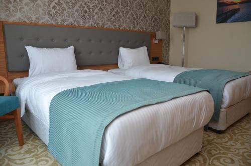 Postel nebo postele na pokoji v ubytování Çınarpark Hotel