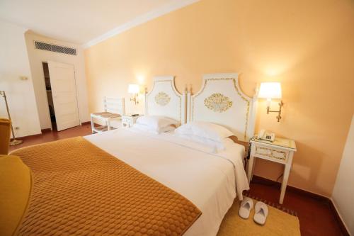 
Een bed of bedden in een kamer bij SL Hotel Santa Luzia – Elvas
