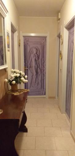 a hallway with a painting of a woman on the wall at appartamento Claudia in Roccalumera
