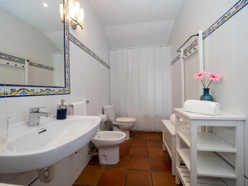 uma casa de banho branca com um lavatório e um WC em eva y maría CASA RURAL em Rañín