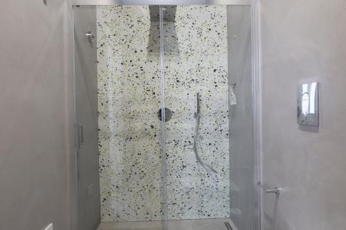 a shower with a glass door in a bathroom at B&B Domus Terra Mare in Torre San Giovanni Ugento