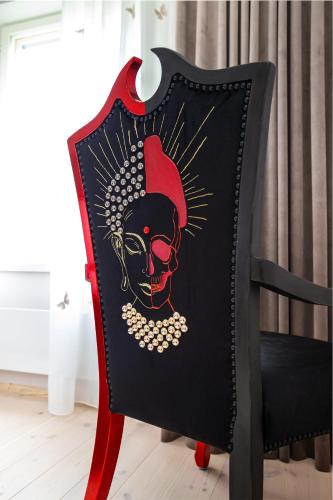 a chair with a skull painted on it at Lakeview beach apartment in Viljandi in Viljandi