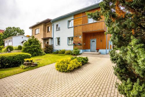 a house with a brick driveway in front of it at Lakeview beach apartment in Viljandi in Viljandi