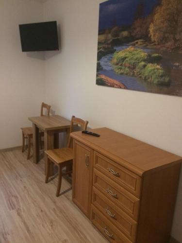a room with a desk and a table and a tv at Tawerna-Stawiska in Garbatka-Letnisko