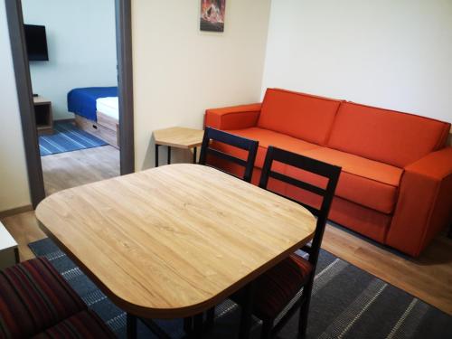 a living room with a table and a couch at Apartments&Camping ZIP in Kremna