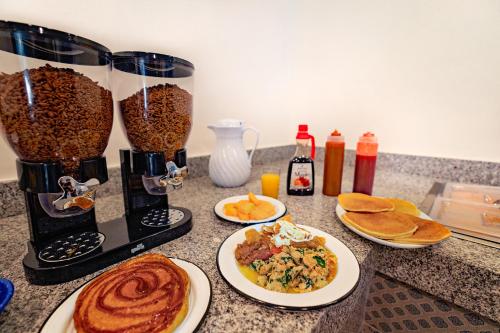 a kitchen counter with plates of food and a blender at Hotel Star in Manzanillo