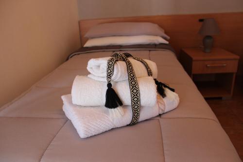 a pile of towels sitting on a bed at B&B La Vigna in Lamezia Terme