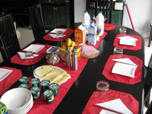 a black table with red napkins and food on it at Brooklyn House in Barnet