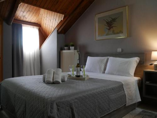 a bedroom with a bed with two towels on it at D&K Studio in Myrina