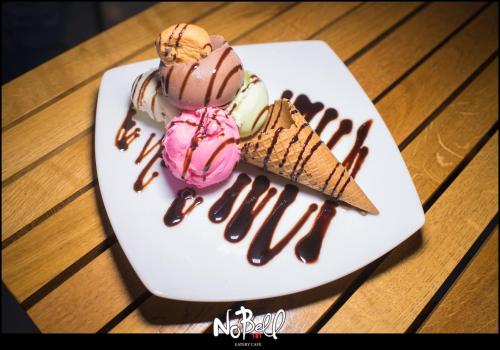 two ice cream desserts on a plate on a table at Daphne Studios in Tsilivi
