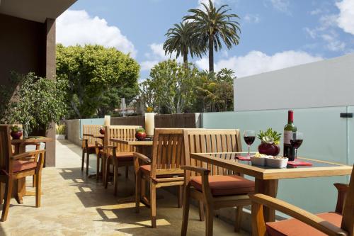 a row of tables and chairs on a patio at Elan Hotel in Los Angeles