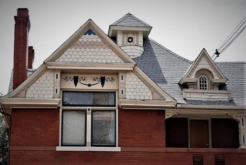 a house with a shingled roof at Off Broadway B & B in Denver