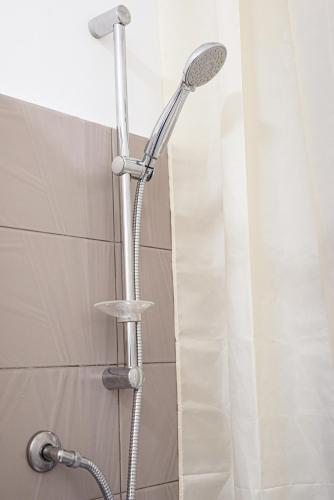 a shower with a shower head in a bathroom at Bed And Breakfast - Lulugiù in Lagonegro