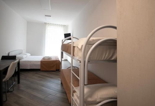 a bedroom with a bunk bed and a bunk room with a bunk bed gmaxwell gmaxwell at Bed And Breakfast - Lulugiù in Lagonegro