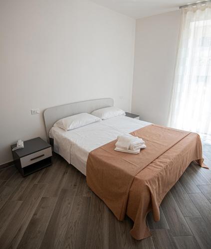 a bedroom with a bed with a towel on it at Bed And Breakfast - Lulugiù in Lagonegro