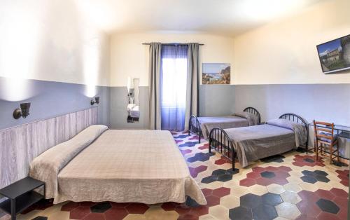 a hospital room with two beds and a window at Albergo La Villetta in Sarzana