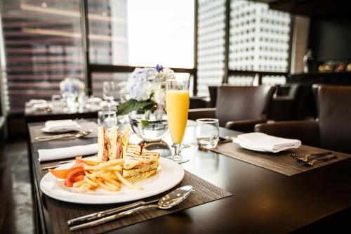 a table with a plate of food and french fries at Fraser Place Namdaemun Seoul in Seoul