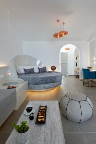 a living room with a bed and a couch at Blue Sea Hotel in Kamari