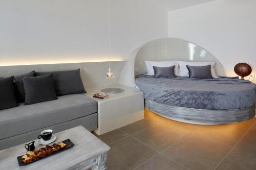a living room with a bed and a couch at Blue Sea Hotel in Kamari