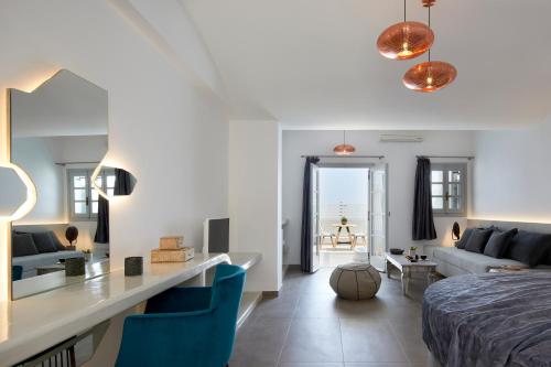 a bedroom with a bed and a living room at Blue Sea Hotel in Kamari