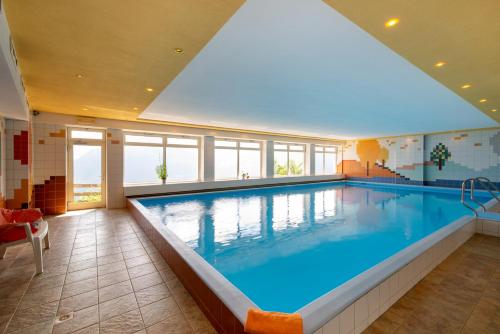 a large swimming pool in a large room at B & B Apartments Ortlerblick in Sluderno