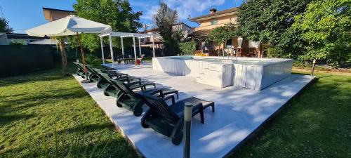 a row of chairs and an outdoor bar in a yard at B&B Isonzo in Turriaco