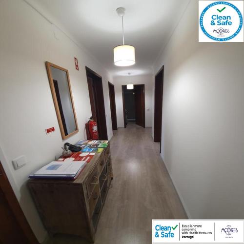a hallway of a room with a desk and a mirror at LEVADA APARTMENT in Ponta Delgada