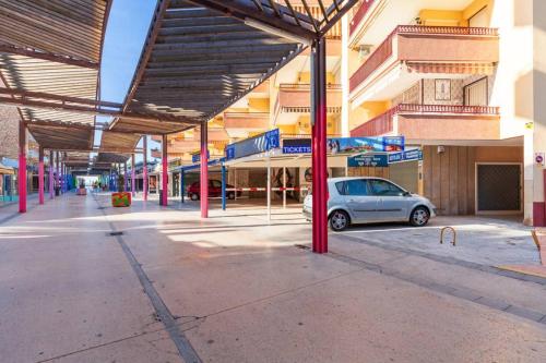a car parked under awning on a city street at Appartement ALFONSO in Salou