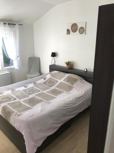 a bedroom with a large bed in a room at Chambres d'hôte du Domaine de la Reine Blanche in Criquetot-sur-Longueville