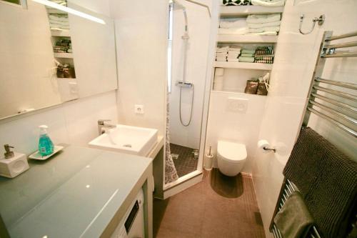 a white bathroom with a sink and a shower at CHARMANT HOME - Mariesol in Nice