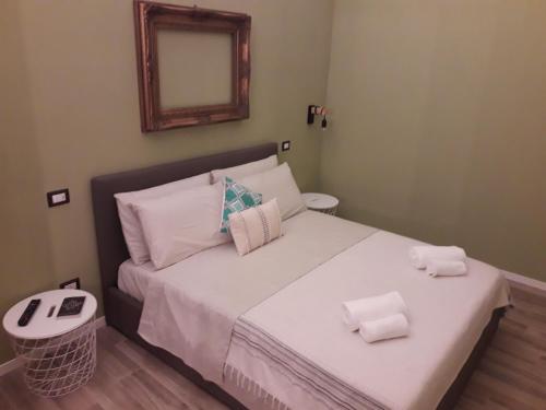 a bedroom with a bed with towels on it at Nuovissimo appartamento lungomare (check out 13:00) in Bari