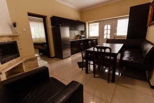 a kitchen and living room with a table and chairs at Bella Villa in Siófok