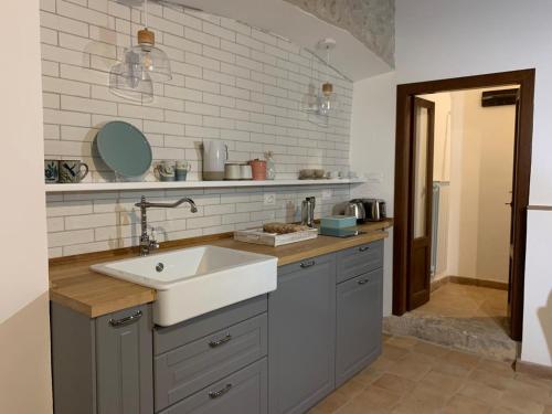 a kitchen with a sink and a counter top at Aurora Medieval House in Sermoneta