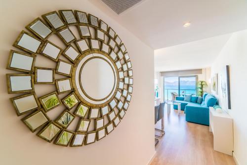 a large mirror on the wall in a living room at Sa Maniga 6G in Cala Millor