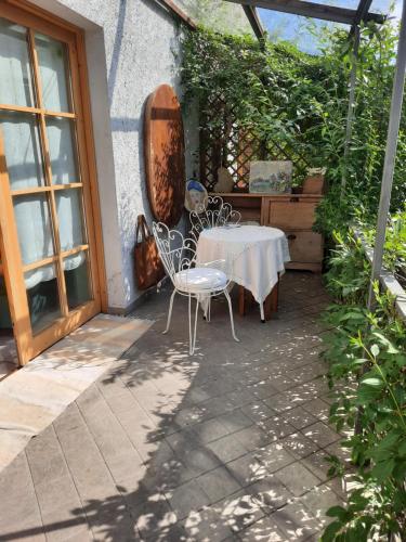 a table and chairs sitting on a patio at Alla Curva di Elia Manzoni in Malè