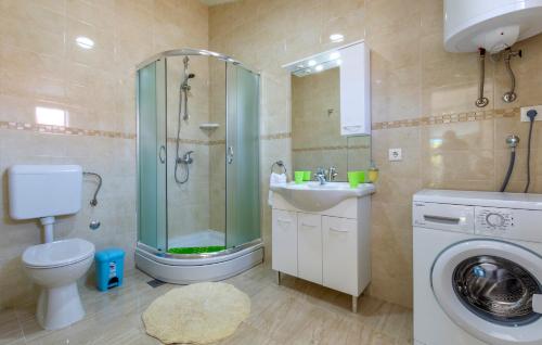 a bathroom with a shower toilet and a sink at Apartments Listes in Milna