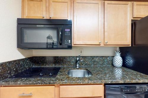 a kitchen with a sink and a microwave at Islander Condominiums I in Fort Walton Beach