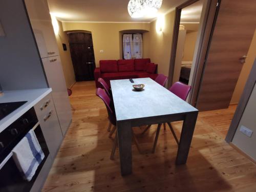 a living room with a table and a red couch at Casa Curnet in Balme