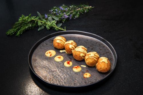 a plate of food with deviled eggs on a table at San Marino Suites by Calm Collection in Fira