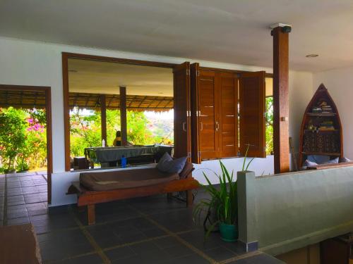 a bathroom with a tub and a large mirror at Merdeka House in Maluk