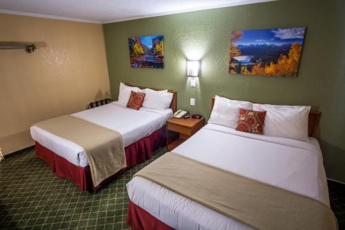 a hotel room with two beds and a telephone at Red River Inn Silt - Rifle in Silt