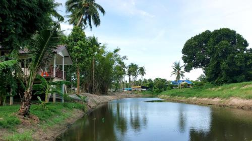 a river with a house on the side of it at Wandee Resort Bankrut in Ban Krut