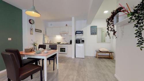 a kitchen and living room with a table and chairs at MIRTA deluxe SUPERIOR 5 star apartment, your piece of heaven by the sea & park, with sea & park view in Novigrad Istria