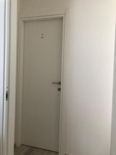 a white door with the number two written on it at B&B Belvedere in Castelluccio Valmaggiore