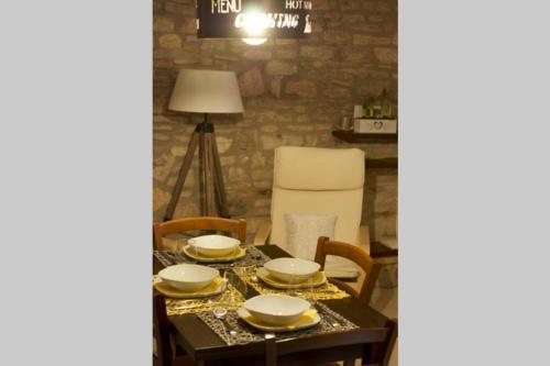 a dining room table with plates and dishes on it at Francesco House Family in Assisi