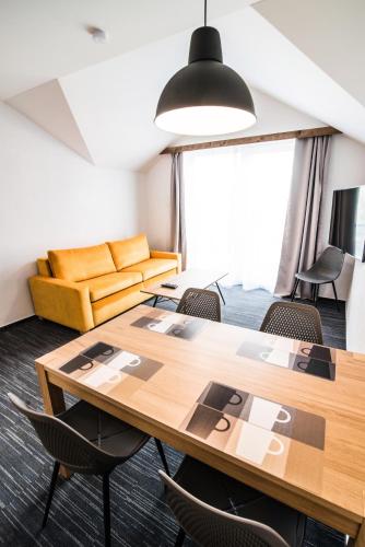 a room with a table and chairs and a couch at Apartmany JA&MA in Liptovský Mikuláš